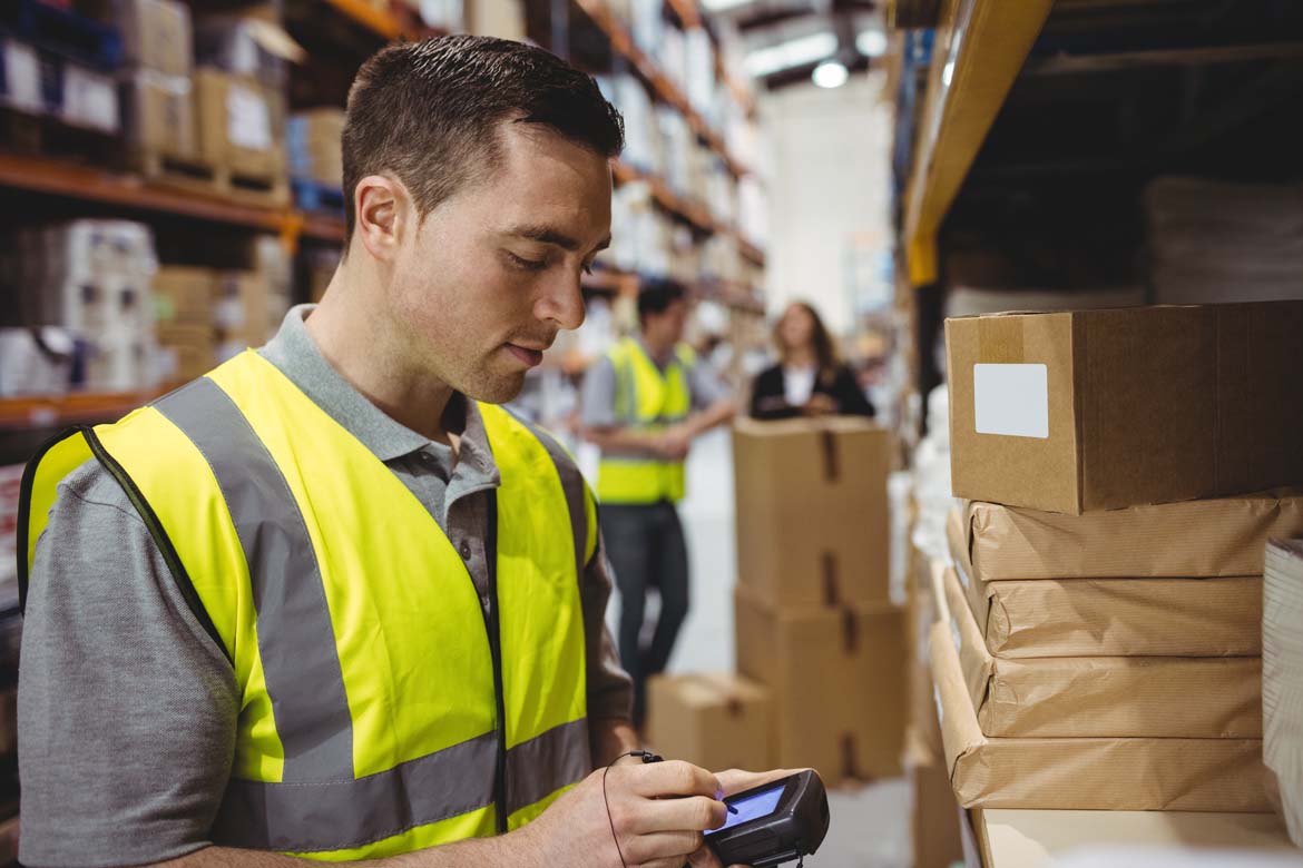 bigstock-Warehouse-worker-scanning-box-121244318.jpg